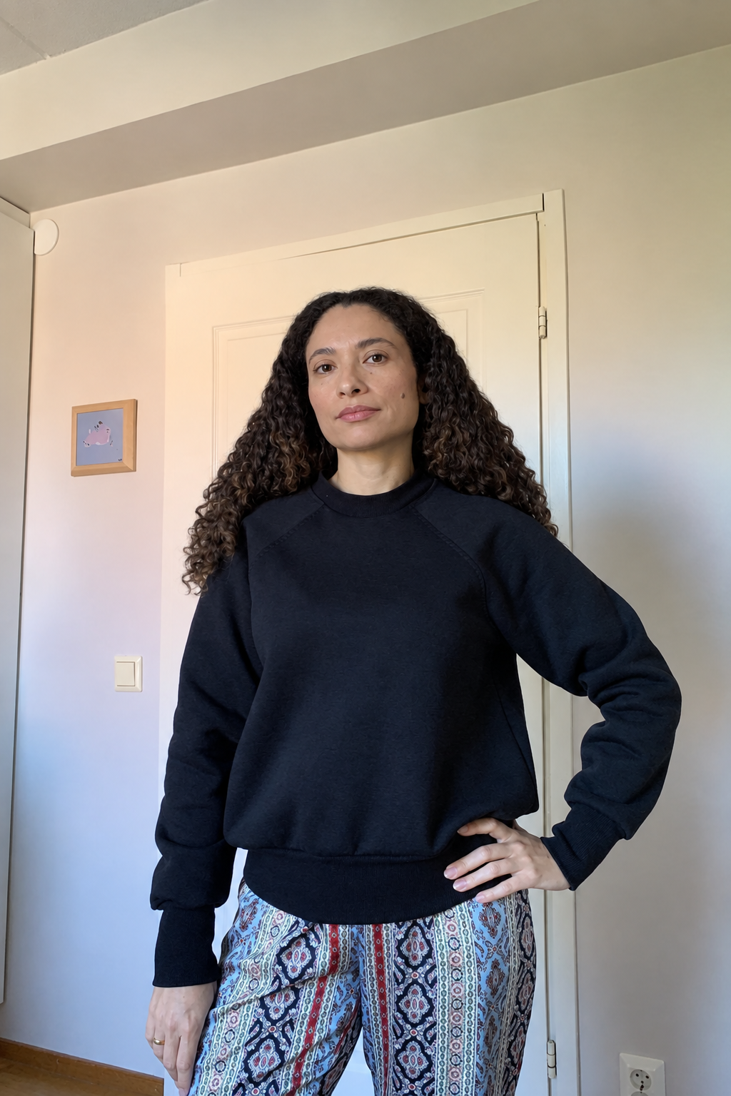 Modelo com camisola preta e cabelo com frizz suavizado